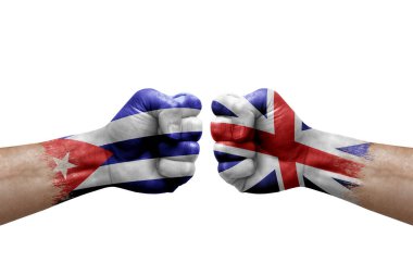 Two hands punch to each others on white background. Country flags painted fists, conflict crisis concept between cuba and britain
