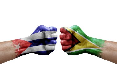 Two hands punch to each others on white background. Country flags painted fists, conflict crisis concept between cuba and guyana