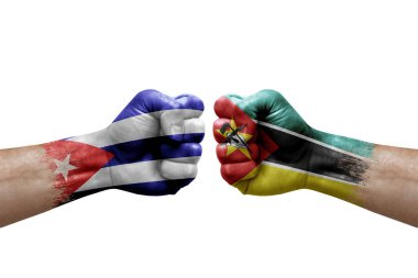 Two hands punch to each others on white background. Country flags painted fists, conflict crisis concept between cuba and mozambique