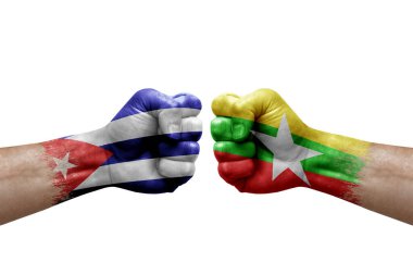Two hands punch to each others on white background. Country flags painted fists, conflict crisis concept between cuba and myanmar