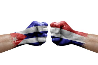 Two hands punch to each others on white background. Country flags painted fists, conflict crisis concept between cuba and netherlands