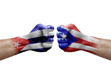 Two hands punch to each others on white background. Country flags painted fists, conflict crisis concept between cuba and puerto rico