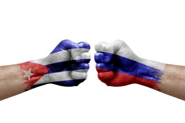 Two hands punch to each others on white background. Country flags painted fists, conflict crisis concept between cuba and russia