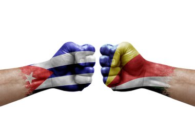 Two hands punch to each others on white background. Country flags painted fists, conflict crisis concept between cuba and seychelles