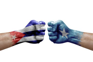 Two hands punch to each others on white background. Country flags painted fists, conflict crisis concept between cuba and somalia
