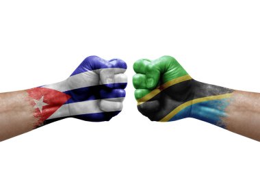 Two hands punch to each others on white background. Country flags painted fists, conflict crisis concept between cuba and tanzania
