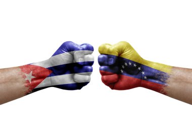 Two hands punch to each others on white background. Country flags painted fists, conflict crisis concept between cuba and venezuela