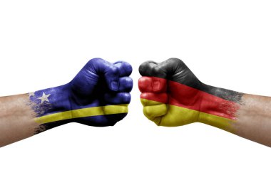 Two hands punch to each others on white background. Country flags painted fists, conflict crisis concept between curacao and germany