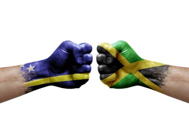 Two hands punch to each others on white background. Country flags painted fists, conflict crisis concept between curacao and jamaica