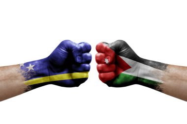 Two hands punch to each others on white background. Country flags painted fists, conflict crisis concept between curacao and jordan