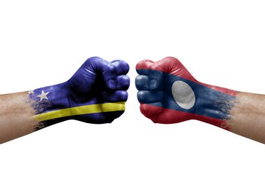 Two hands punch to each others on white background. Country flags painted fists, conflict crisis concept between curacao and laos