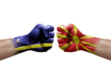 Two hands punch to each others on white background. Country flags painted fists, conflict crisis concept between curacao and north macedonia