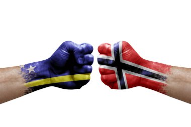 Two hands punch to each others on white background. Country flags painted fists, conflict crisis concept between curacao and norway