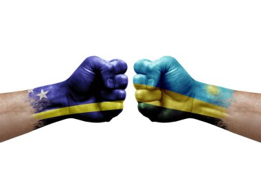 Two hands punch to each others on white background. Country flags painted fists, conflict crisis concept between curacao and rwanda