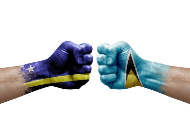 Two hands punch to each others on white background. Country flags painted fists, conflict crisis concept between curacao and saint lucia