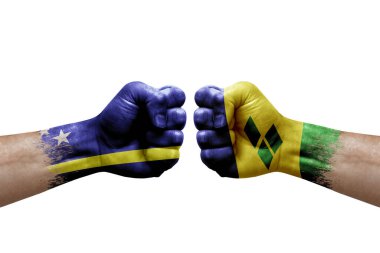 Two hands punch to each others on white background. Country flags painted fists, conflict crisis concept between curacao and saint vincent and the grenadines