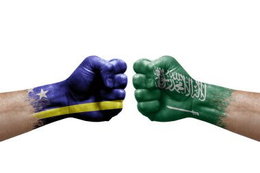 Two hands punch to each others on white background. Country flags painted fists, conflict crisis concept between curacao and saudi arabia