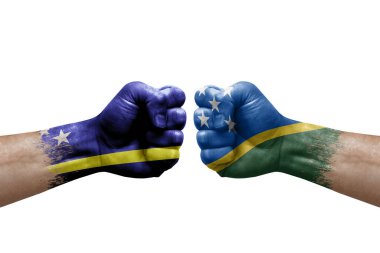 Two hands punch to each others on white background. Country flags painted fists, conflict crisis concept between curacao and solomon islands