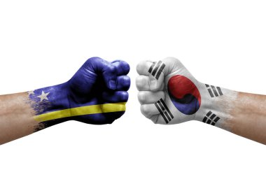 Two hands punch to each others on white background. Country flags painted fists, conflict crisis concept between curacao and south korea