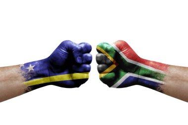 Two hands punch to each others on white background. Country flags painted fists, conflict crisis concept between curacao and south africa