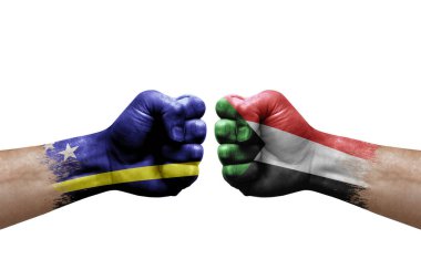 Two hands punch to each others on white background. Country flags painted fists, conflict crisis concept between curacao and sudan