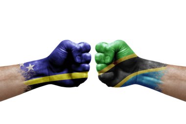 Two hands punch to each others on white background. Country flags painted fists, conflict crisis concept between curacao and tanzania