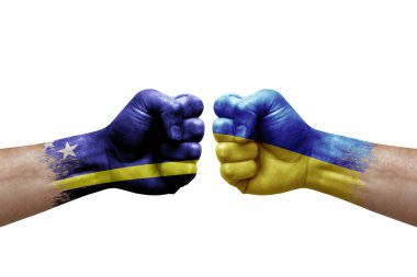 Two hands punch to each others on white background. Country flags painted fists, conflict crisis concept between curacao and ukraine