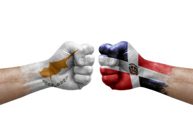 Two hands punch to each others on white background. Country flags painted fists, conflict crisis concept between cyprus and dominican republic