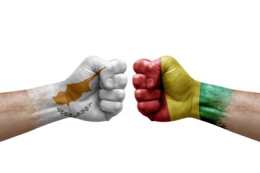 Two hands punch to each others on white background. Country flags painted fists, conflict crisis concept between cyprus and guinea