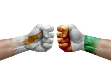 Two hands punch to each others on white background. Country flags painted fists, conflict crisis concept between cyprus and ivory coast