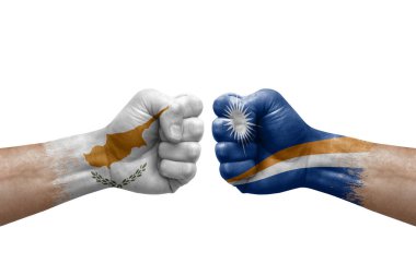 Two hands punch to each others on white background. Country flags painted fists, conflict crisis concept between cyprus and marshall islands