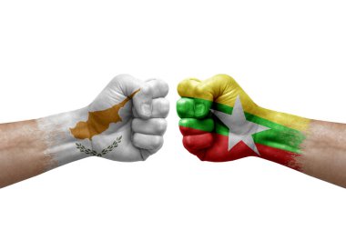 Two hands punch to each others on white background. Country flags painted fists, conflict crisis concept between cyprus and myanmar