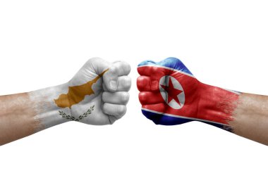Two hands punch to each others on white background. Country flags painted fists, conflict crisis concept between cyprus and north korea