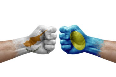 Two hands punch to each others on white background. Country flags painted fists, conflict crisis concept between cyprus and palau