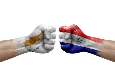 Two hands punch to each others on white background. Country flags painted fists, conflict crisis concept between cyprus and paraguay