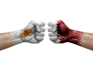 Two hands punch to each others on white background. Country flags painted fists, conflict crisis concept between cyprus and qatar