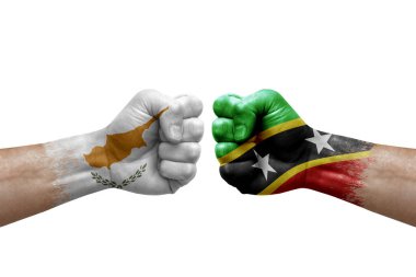 Two hands punch to each others on white background. Country flags painted fists, conflict crisis concept between cyprus and saint kitts and nevis