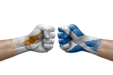 Two hands punch to each others on white background. Country flags painted fists, conflict crisis concept between cyprus and scotland