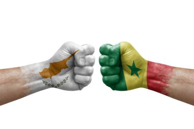 Two hands punch to each others on white background. Country flags painted fists, conflict crisis concept between cyprus and senegal