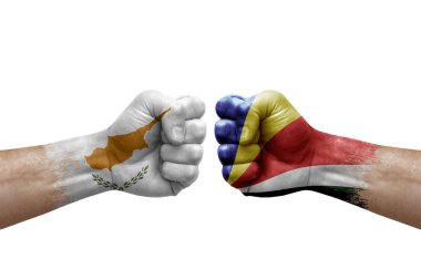 Two hands punch to each others on white background. Country flags painted fists, conflict crisis concept between cyprus and seychelles