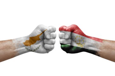 Two hands punch to each others on white background. Country flags painted fists, conflict crisis concept between cyprus and tajikistan