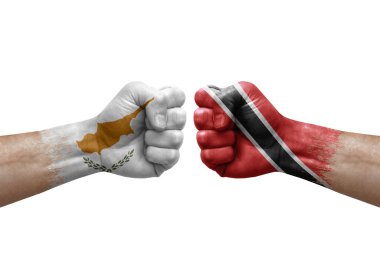 Two hands punch to each others on white background. Country flags painted fists, conflict crisis concept between cyprus and tobago