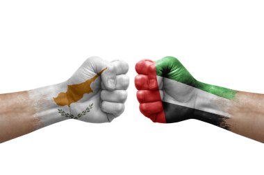 Two hands punch to each others on white background. Country flags painted fists, conflict crisis concept between cyprus and united arab emirates