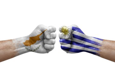 Two hands punch to each others on white background. Country flags painted fists, conflict crisis concept between cyprus and uruguay
