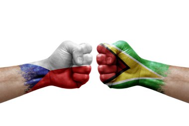 Two hands punch to each others on white background. Country flags painted fists, conflict crisis concept between czechia and guyana