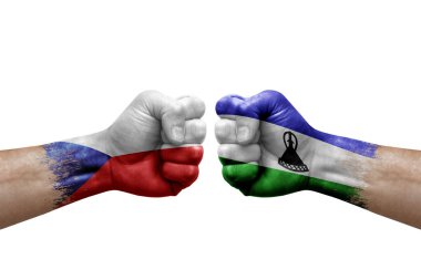 Two hands punch to each others on white background. Country flags painted fists, conflict crisis concept between czechia and lesotho