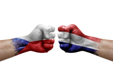 Two hands punch to each others on white background. Country flags painted fists, conflict crisis concept between czechia and netherlands
