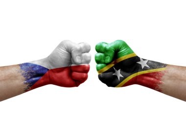 Two hands punch to each others on white background. Country flags painted fists, conflict crisis concept between czechia and saint kitts and nevis