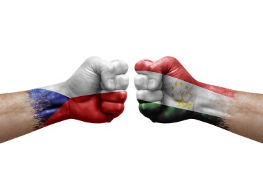Two hands punch to each others on white background. Country flags painted fists, conflict crisis concept between czechia and tajikistan