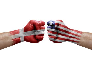 Two hands punch to each others on white background. Country flags painted fists, conflict crisis concept between denmark and liberia